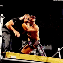 two men are wrestling in a dark room with the words " the next big thing " on the bottom