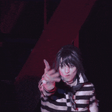 a blurry picture of a person in a striped shirt with a collar