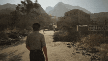a man is walking down a dirt road in front of a sign that says collezolfe