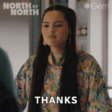 a woman in a floral shirt says " thanks "