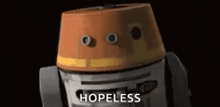 a robot with a cone on its head and the words `` hopeless '' written on it 's face .