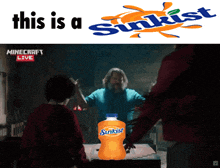a bottle of sunkist sits on a table next to a man