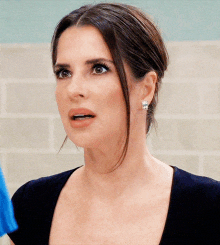 a woman with a surprised look on her face is wearing earrings
