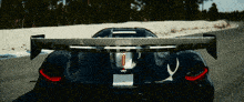 a black car with a wing that says koenigsegg