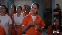 a group of women in orange jumpsuits are sitting in a netflix ad