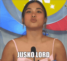 a woman in a pink tank top with the words jusko lord written on her chest