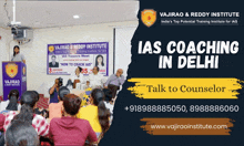 a group of people sitting in front of a sign that says " ias coaching in delhi "