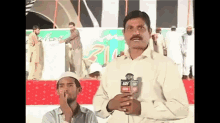 a man holding a microphone that says ary news