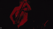 a man playing a guitar in the air with the letter d in the corner