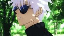 a close up of a person wearing sunglasses and a black shirt