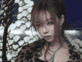 a girl with red hair is wearing a leopard print jacket