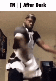 a man in a maid costume is dancing in a room with the words tn after dark on the bottom .