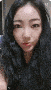 a close up of a woman 's face with the letter m above her head