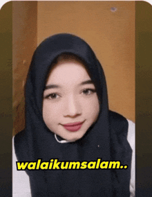 a woman wearing a black hijab says ' awalikumsalam ' on the bottom