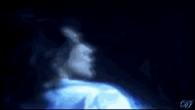 a man is singing into a microphone in the dark .