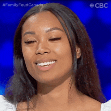 a close up of a woman 's face with the words family feud canada on the bottom left