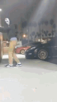 a person wearing a mask is standing in front of a parking lot