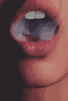 a close up of a woman smoking a cigarette