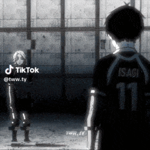 a man with the number 11 on his back is standing next to another person