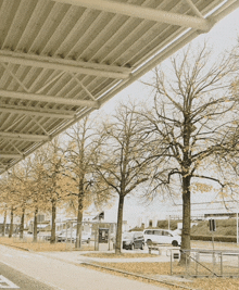 a parking lot with cars parked under a canopy