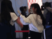 a girl in a white shirt with the letter bs on the back