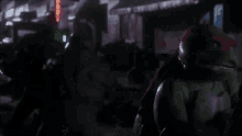 a group of teenage mutant ninja turtles are walking down a street .