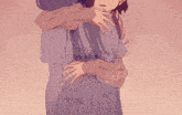 a girl in a purple dress is hugging another girl in a pink shirt