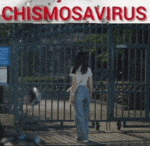 a woman walks past a sign that says chismosaurus