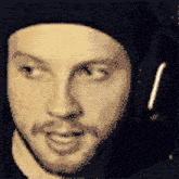 a pixelated portrait of a man with a beard