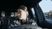 a woman is sitting in a car with shopcam 7 a 15 written on the screen