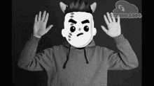 a black and white photo of a person wearing a hoodie with a cartoon face on it