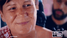 a close up of a woman 's face with a man behind her .