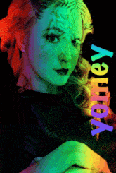 a woman 's face is surrounded by a rainbow of colors and the word voley is on the bottom right