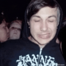 a young man wearing a black hoodie with the word hanna on it .