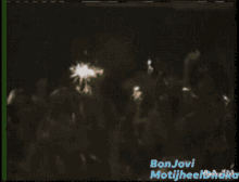 a man singing into a microphone with the name bonjovi on the bottom right