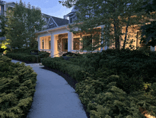 a white house with a porch and a walkway