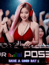 a woman wearing headphones stands in front of a sign that says ' pose have a good day '