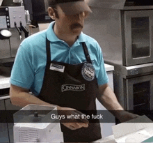 a man wearing a blue shirt and an apron that says cinnabon on it