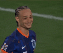 a soccer player wearing a number 1 jersey is smiling