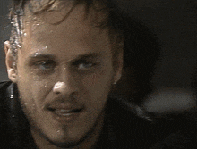 a close up of a man 's face with water coming out of it