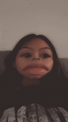 a girl wearing a shirt that says army makes a face