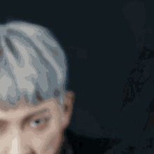 a close up of a person 's face with their mouth open and their hand on their chin