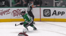 a hockey player in a green jersey with the number 36