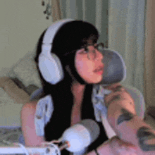 a woman wearing headphones is sitting in front of a microphone .