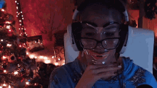 a woman wearing glasses and headphones has a clown face drawn on her face