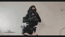 a woman is holding a gun in front of a destiny crossplay banner