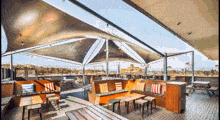 a patio area with tables and chairs under a roof