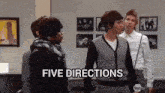 a group of people standing in a room with the words five directions written on the bottom .