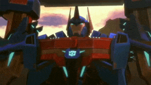 a red and blue robot with the word transformers on its chest