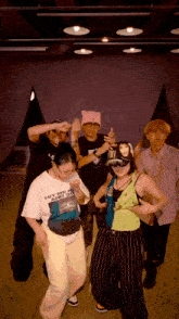 a group of people are dancing and one of them is wearing a shirt that says hit me